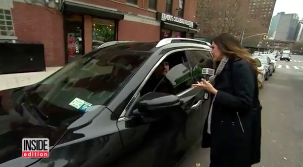 Inside Edition reporter Lisa Guerrero confronts an NYPD officer about his illegal license plate cover. Image: Inside Edition