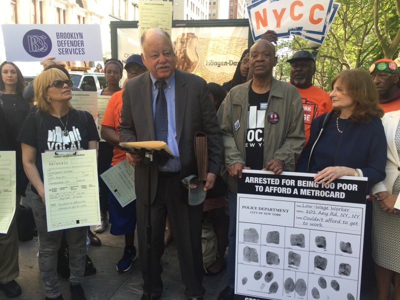 MTA board member and Community Service Society CEO David Jones (podium) speaking last month alongside criminal justice advocates and Riders Alliance members. Photo: David Meyer