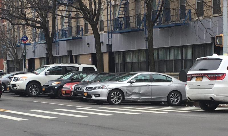 Personal police vehicles line the length of this M10 bus stop on Frederick Douglass Boulevard. Photo: Max Krauss