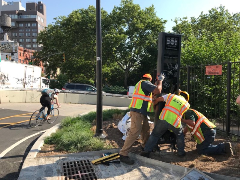 DOT crews installing the bike counter at Forsyth Plaza this morning. Photo: NYC DOT