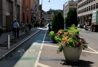 The Downtown Brooklyn Partnership now has 56 planters maintaining the integrity of the Jay Street bike lane, up from 12 in early 2017. Photo: Downtown Brooklyn Partnership
