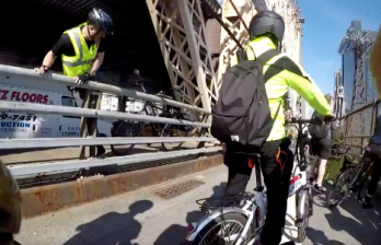 Cyclists pulled their bikes onto the roadway rather than wait 45 minutes for the president. Photo: Steve Bodzin
