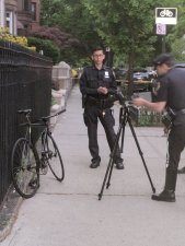 Police photograph the victim's bike after he was hit by a driver on May 11 in Crown Heights. Photo: Marco Conner.