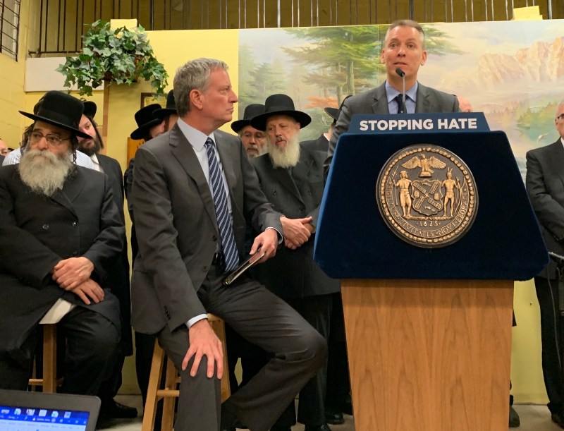 NYPD Commissioner Dermot Shea looming over his boss in a file photo.