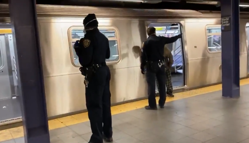 Police roust homeless individuals from the subway on Wednesday. Photo: Josh Dean