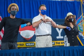 Gov. Cuomo flanked by bigger stars, Chris Rock and Rosie Perez on Wednesday. Photo: Darren McGee/Governor's office