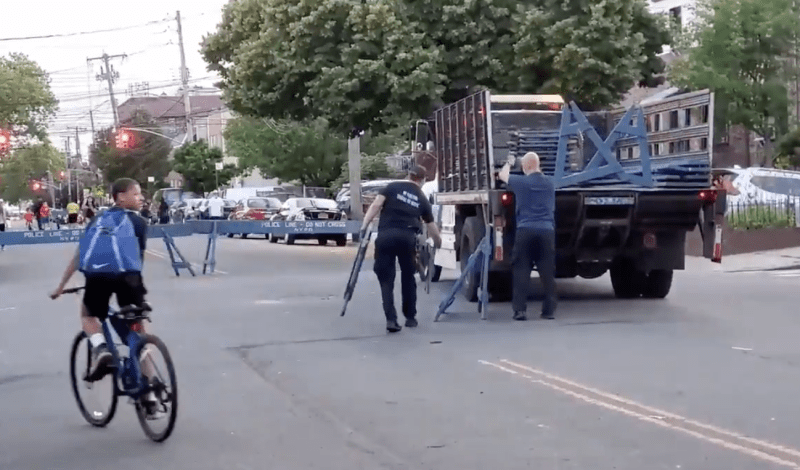 Police workers remove barricades so that car drivers once again have full access to the open street portion of Rhinelander Avenue at the expense of COVID-19 open space protocols. Photo: Michael Kaess