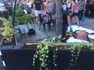 Paramedics help a victim after a pickup truck plowed through an outdoor dining area in Sunset Park on Tuesday. Photo: Lincoln Restler