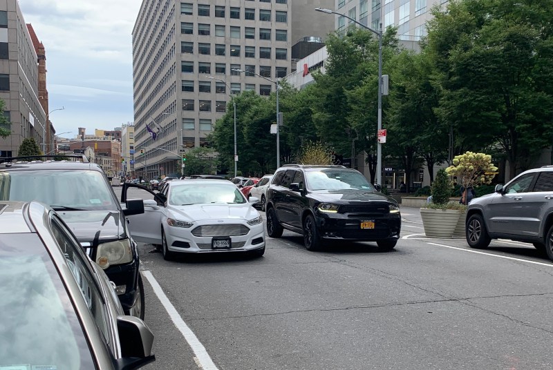 Meet the new Jay Street, same as the old Jay Street: A driver moves around a double-parked car on the Jay Street busway. Photo: Gersh Kuntzman