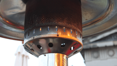 A propane lamp will warm you during your outdoor meal, but it will also warm up the planet. Photo: Mark Longair via Flickr