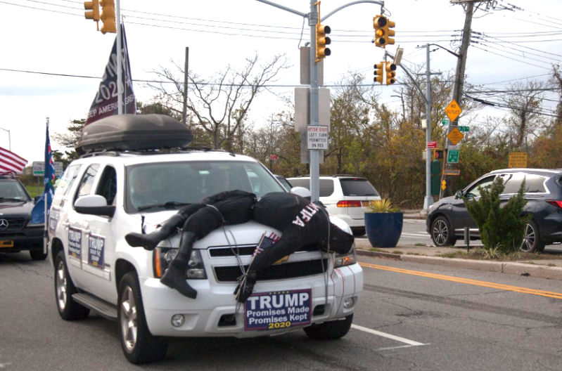 A Trump-supporter sported an effigy of a dead Antifa activist as a hood ornament on an SUV with illegally obscured license plates in Queens on Sunday. Photo: Via Twitter