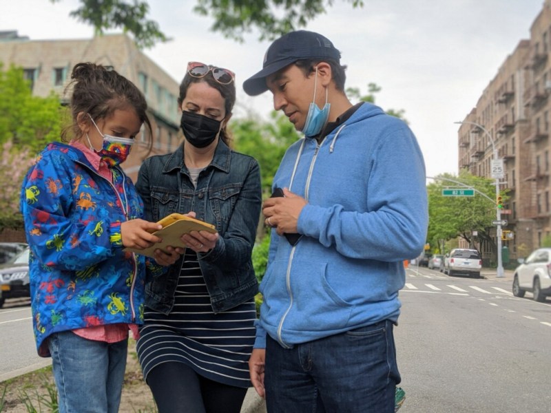 Steven and Anna Moyano signing the new open streets petition on Sunday with their son, Gabriel.