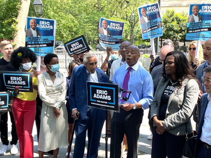 Eric Adams speaks at a podium during a rally with his supporters outside City Hall in May.