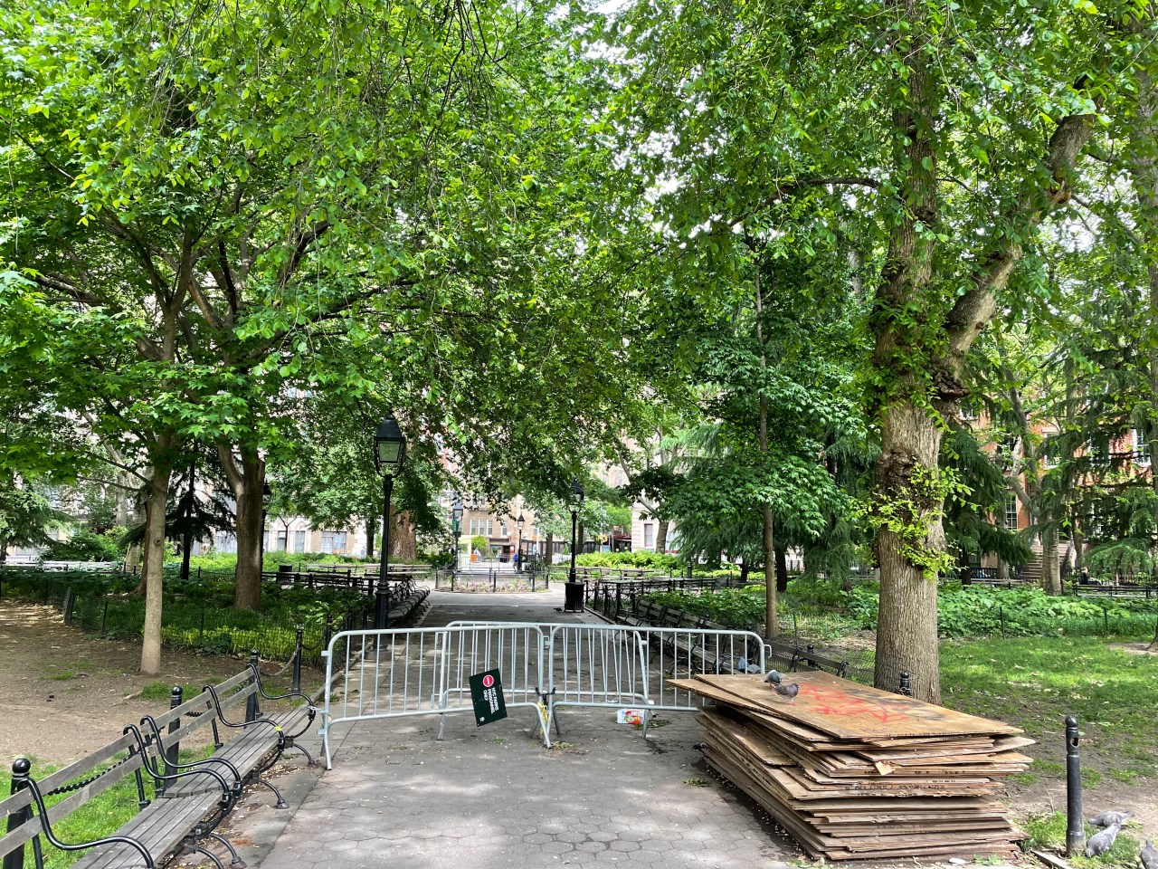 A metal barricade seals off the northwestern quadrant of Washington Square Park.