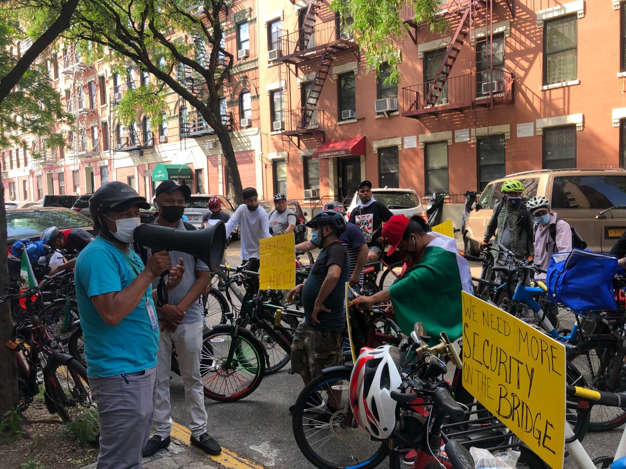 Sergio Salano speaking to crowd of delivery workers outside of 25th precinct. Photo: Fiifi Frimpong