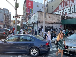 Pedestrians cross a congestion Canal Street.
