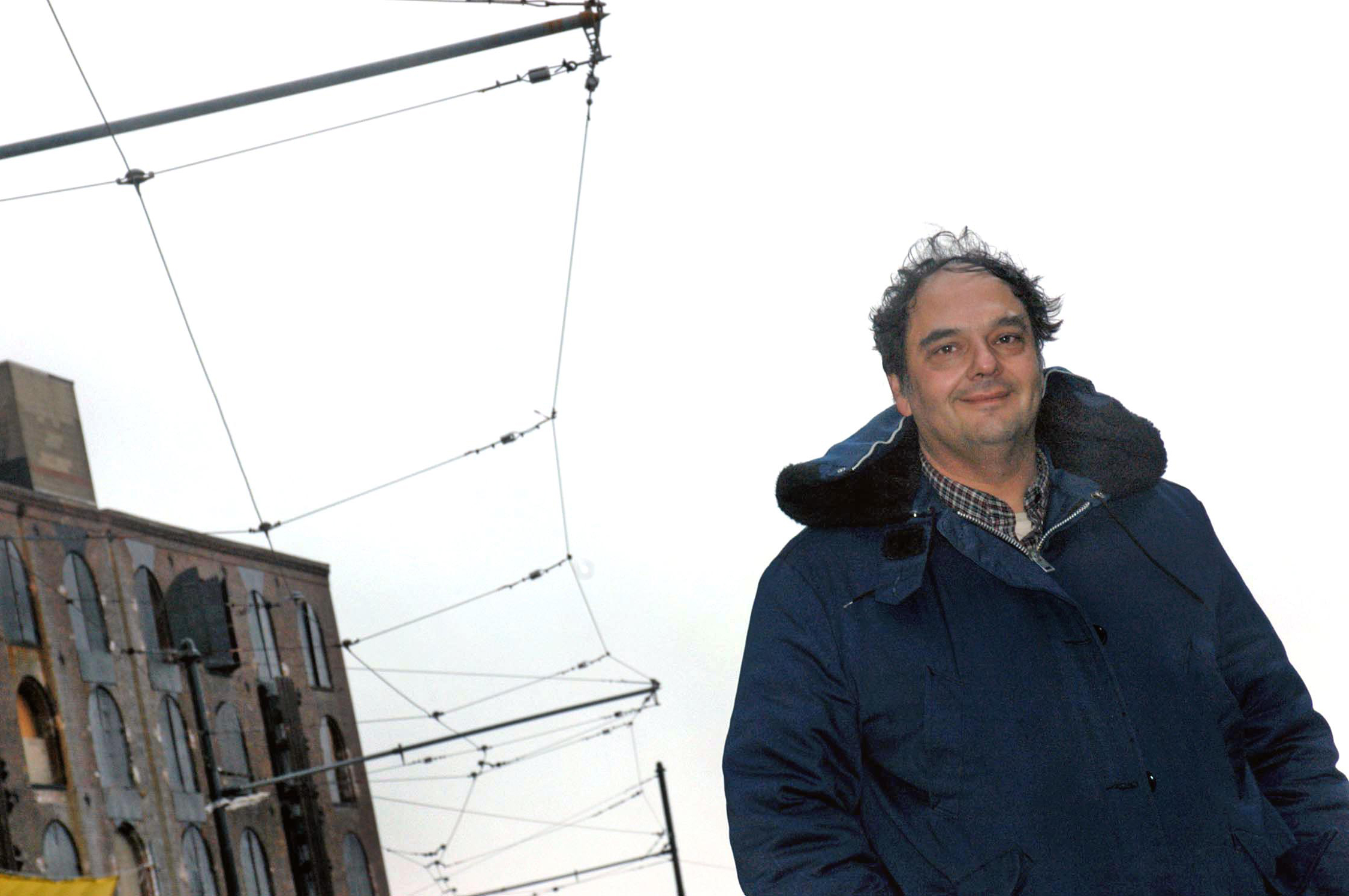 In this archival shot from 2003, Bob Diamond stands underneath the electrical lines that power his vintage trolleys. Photo: Gregory P. Mango